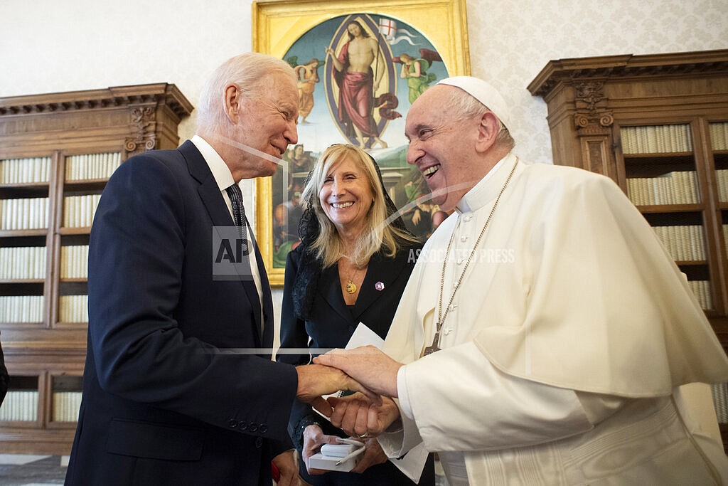 US President Joe Biden, left, shakes hands with Pope Francis as they meet at the Vatican, Friday, Oct. 29, 2021. President Joe Biden is set to meet with Pope Francis on Friday at the Vatican, where the world’s two most notable Roman Catholics plan to discuss the COVID-19 pandemic, climate change and poverty. The president takes pride in his Catholic faith, using it as moral guidepost to shape many of his social and economic policies. (Vatican Media via AP)