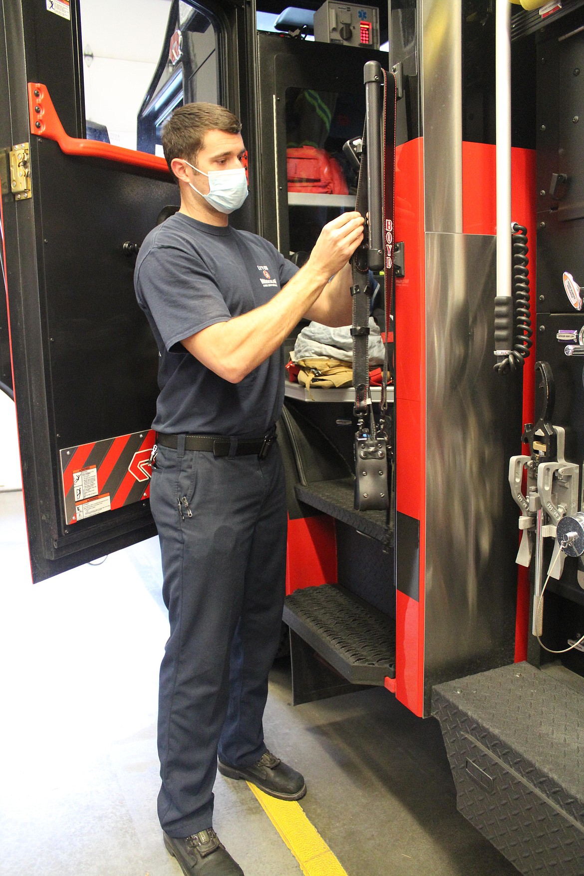 Moses Lake Fire Department firefighter/EMT Dustin Boyd checks equipment on a fire truck. He was hired Wednesday, with an official start date of Nov. 7, by the department after eight months as a provisional firefighter and several years as a volunteer for Grant County Fire District 5. Boyd replaces firefighter MIchael Evens, who decided to resign.