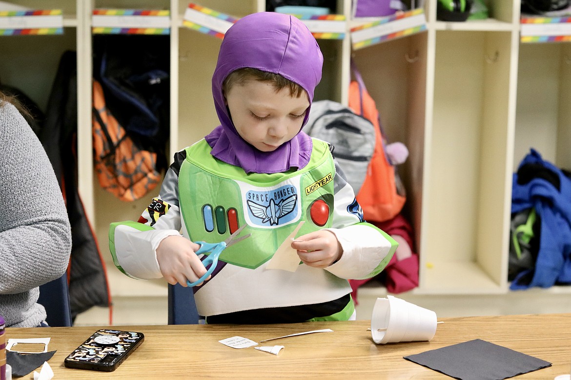 Six-year-old Charlie Young, dressed for Halloween as Buzz Lightyear, creates a bat cave as part of the Halloween-themed STEM activities at Fernan STEM Academy in Coeur d'Alene on Friday. HANNAH NEFF/Press