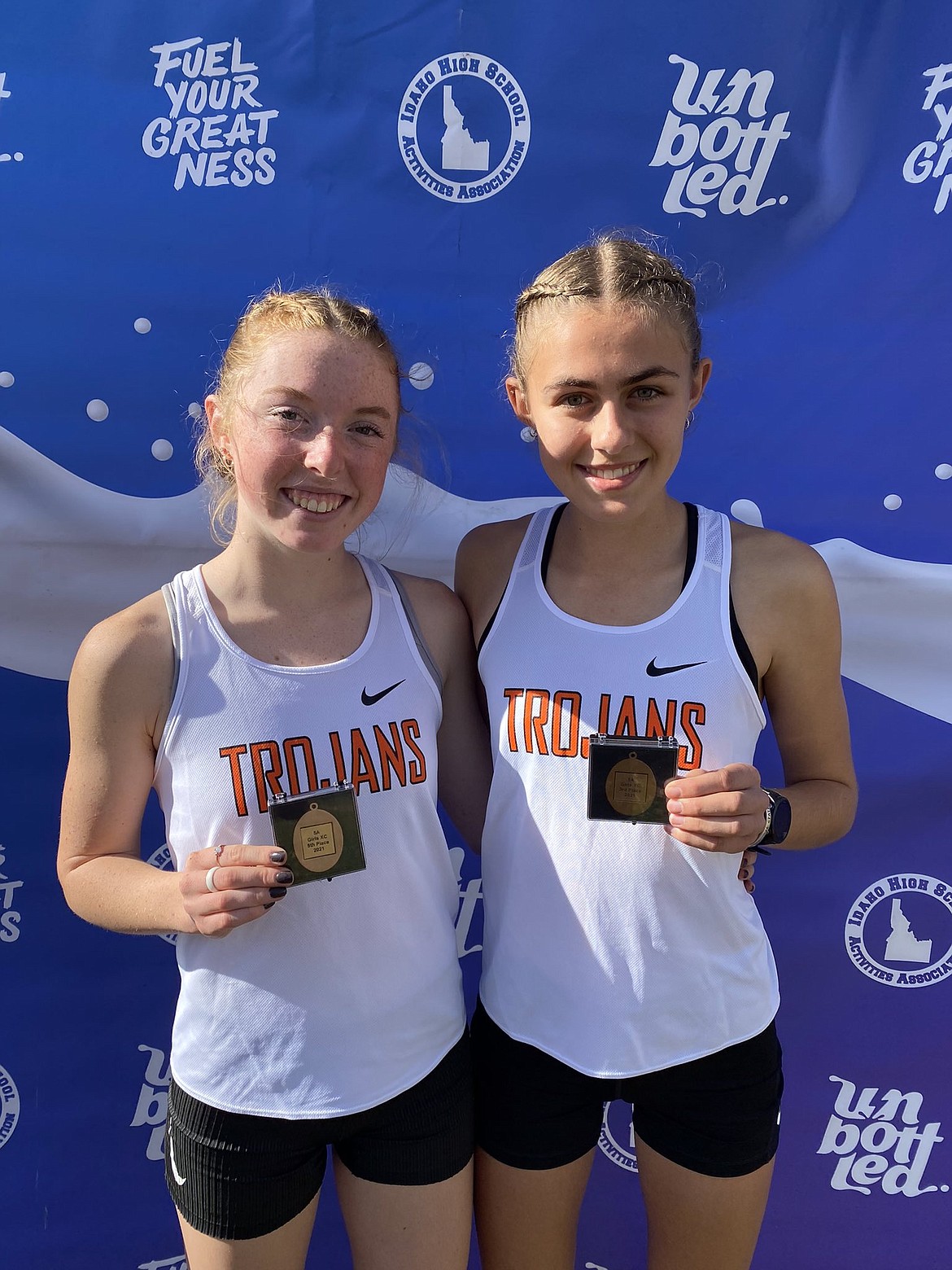 POST FALLS HIGH
Post Falls High senior Sammie Wood, left, and junior Annastasia Peters, display their medals after finishing in the top 20 at the state 5A cross country meet on Friday at Eagle Island State Park. Wood finished fifth and Peters third for the Trojans.