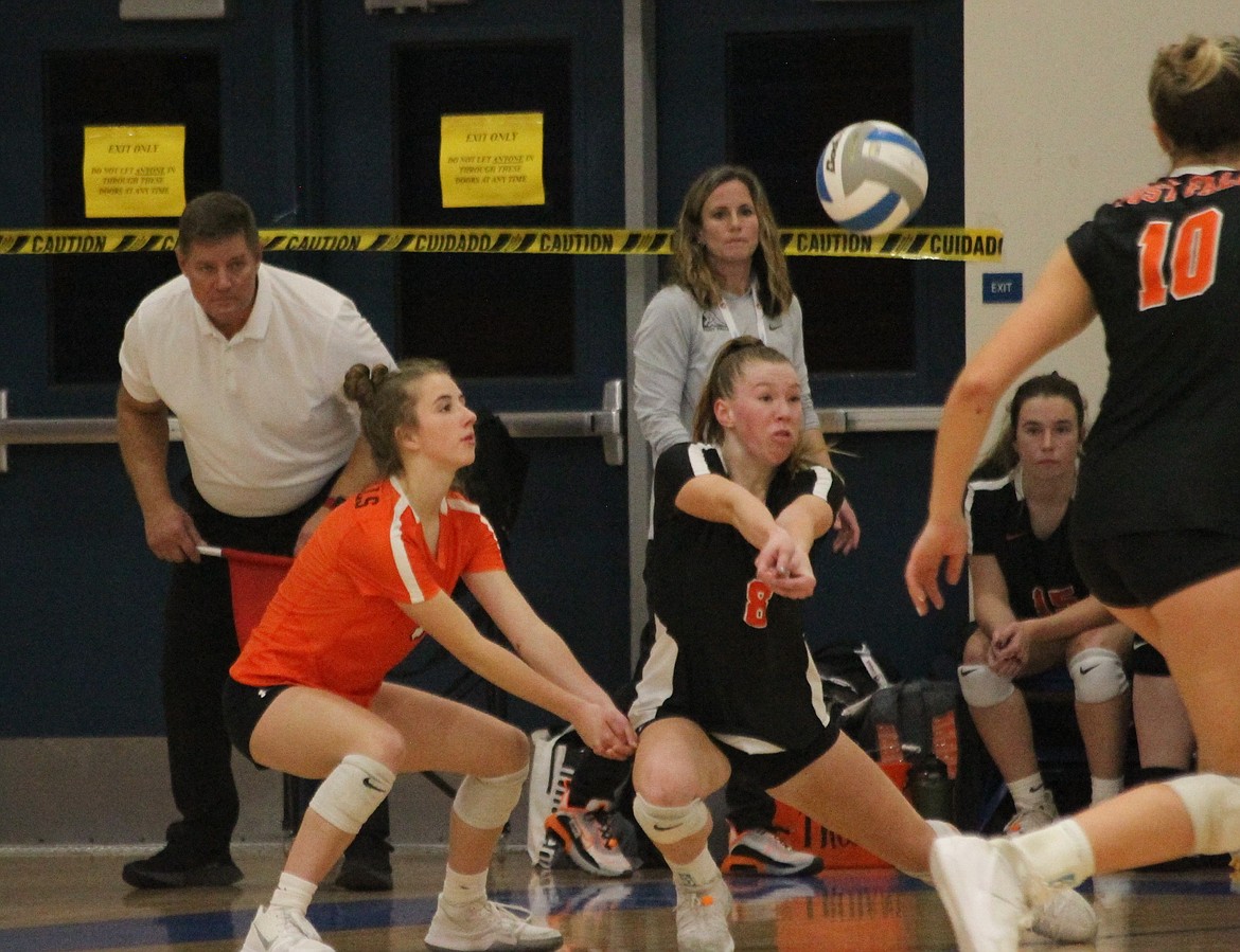 MARK NELKE/Press
Claire Holding, left, and Sarah Rogne of Post Falls zero in on the pass during a match against Madison of Rexburg on Friday afternoon at the state 5A volleyball tournament at Coeur d'Alene High.
