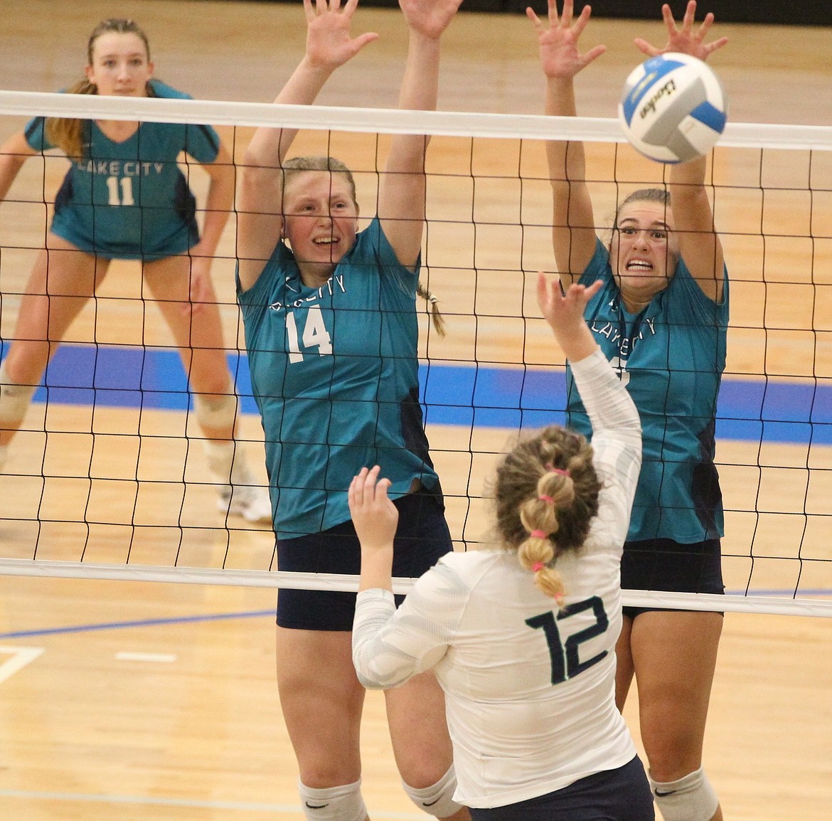 MARK NELKE/Press
Emberlyn Reynolds (14) and Dorie Kiesbuy of Lake City put up a block against Riley Kaiser of Mountain View on Friday afternoon at the state 5A volleyball tournament at Coeur d'Alene High.