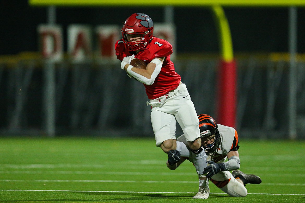 Junior wide receiver Cody Newhart tries to break through a shoelace tackle on Friday.