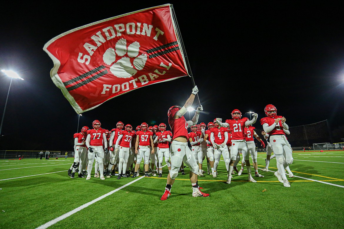 Senior Gerrit Cox waves the flag prior to Friday's game.