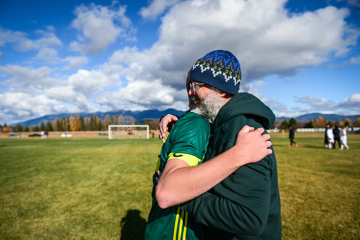 Whitefish head coach John Lacey celebrates with Aaron Dicks after the Bulldogs' 3-2 win over Columbia Falls in the State A championship at Smith Fields on Saturday, Oct. 30. (Casey Kreider/Daily Inter Lake)