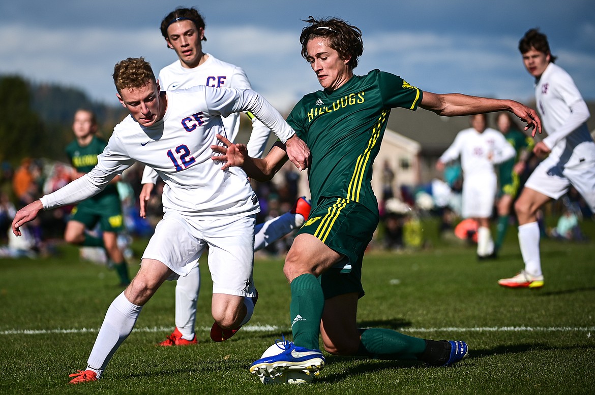 Whitefish's Gabe Menicke (9) pushes the ball into the box against Columbia Falls' Andrew Miner (12) in the second half of the State A championship against Columbia Falls at Smith Fields on Saturday, Oct. 30. (Casey Kreider/Daily Inter Lake)