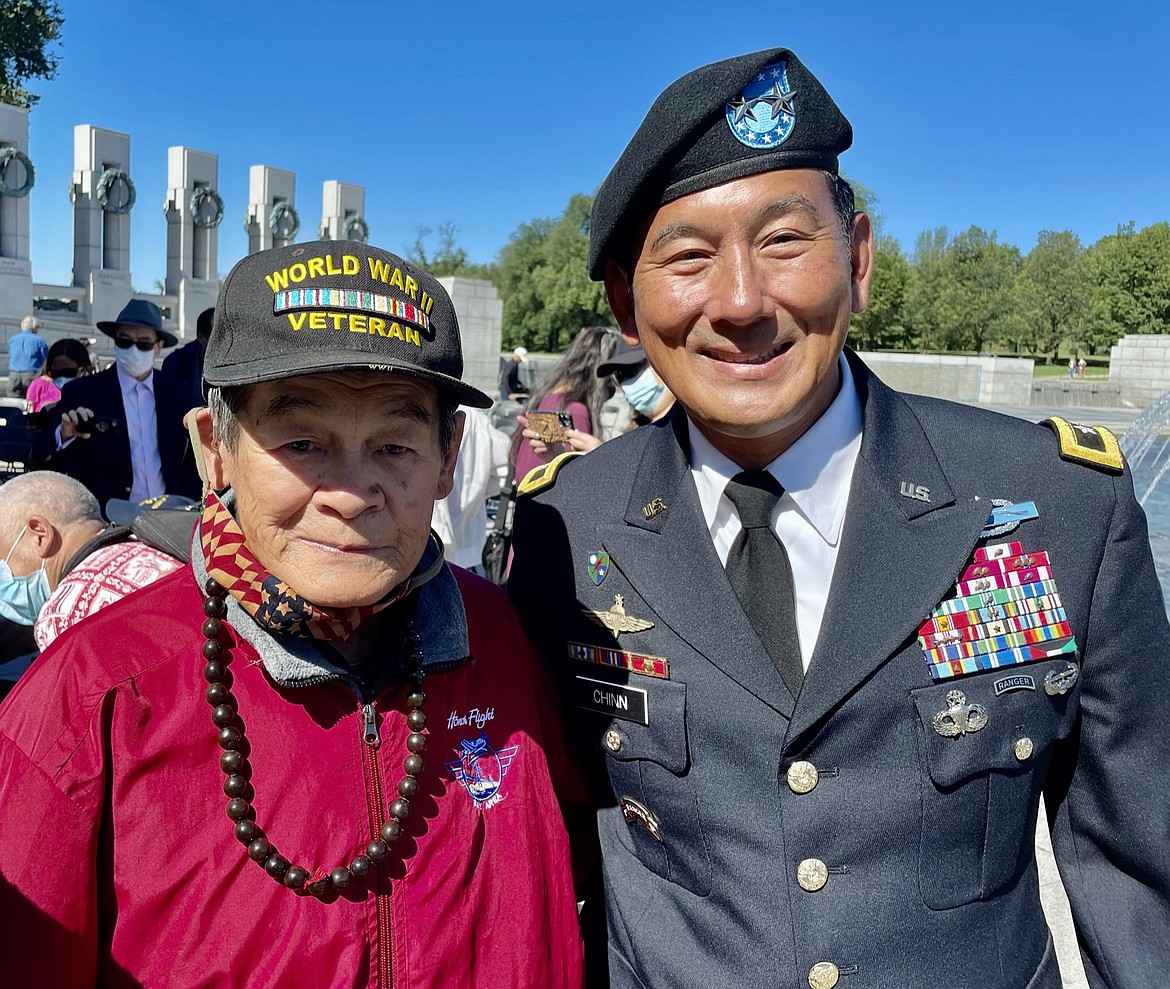 George Dong, left, at a ceremony laying a wreath at the World War II Memorial.