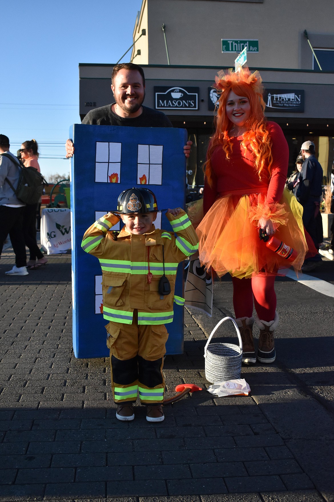 Tom Silva is dressed as a burning building, his wife, KaiLani, is dressed as fire, while their son Henry is dressed as a firefighter.