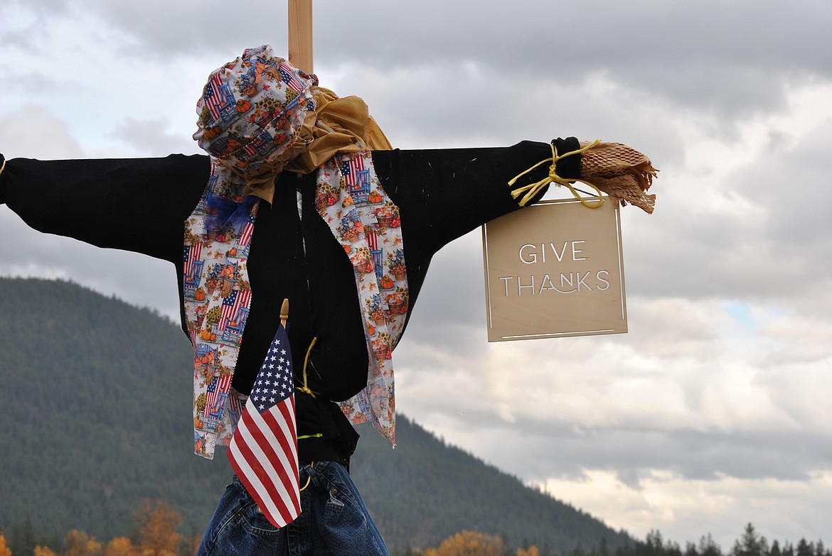 This entry says it all. "Give Thanks" is displayed along with a patriotic sash and flag, it appears this scarecrow is bowing its head in praise.