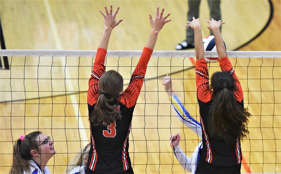 Olivia Clairmont (3) and Leina Ulutoa go up for a block against Libby. (Scot Heisel/Lake County Leader)
