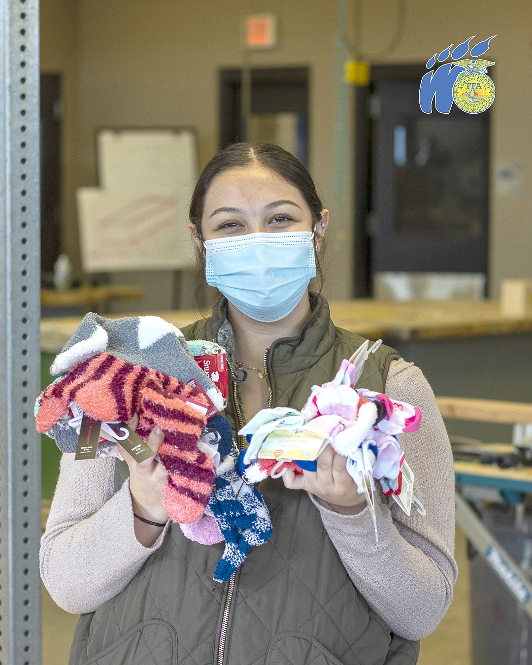 Samaria Reyes holds up some of the socks donated to the sock drive.