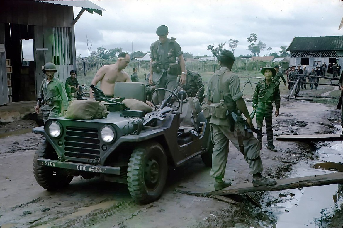 SSgt. Bill Hunt (no shirt) is pictured loading a Jeep in 1966 as he works with indigenous soldiers during his third tour in Vietnam.
