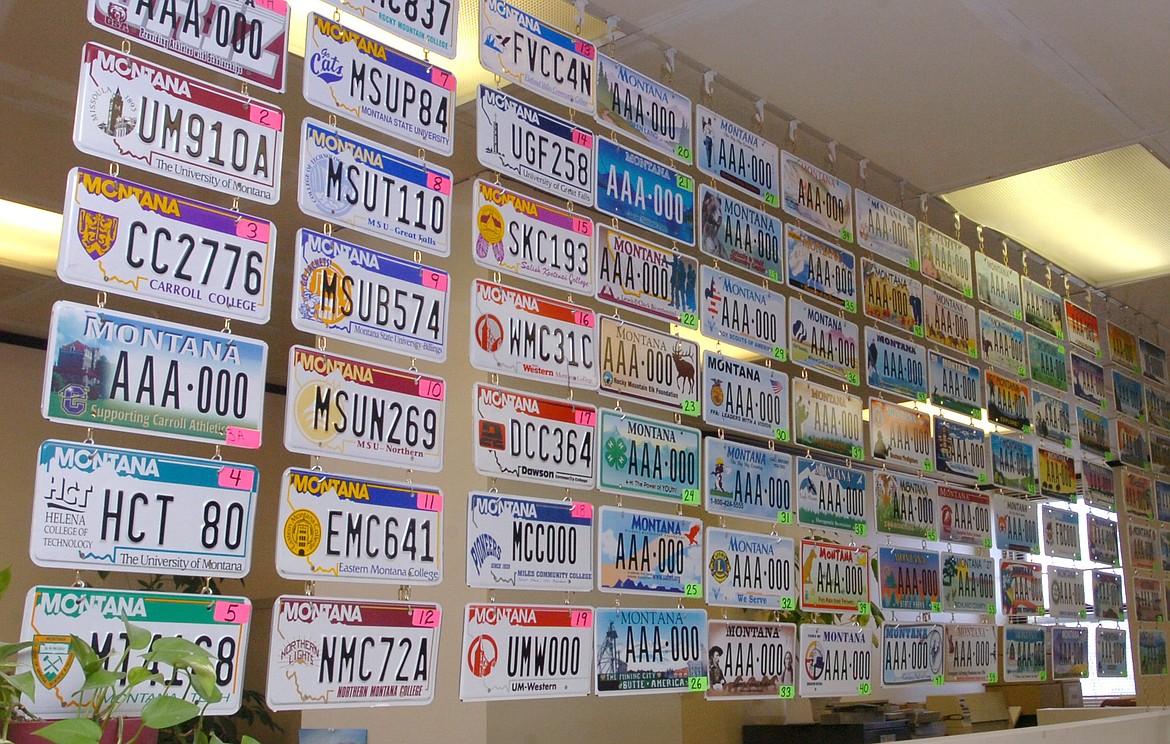 FILE - A variety of Montana specialty license plates are on display in the basement of the Cascade County Courthouse in Great Falls, Montana, on March 5, 2008. A shortage of aluminum has led to a temporary disruption in the manufacturing of license plates at the Montana State Prison in Deer Lodge. Counties do have some plates in stock, but Montana Correctional Enterprises will print temporary plates if the stockpile runs out. (Stuart S. White/Great Falls Tribune via AP, File)