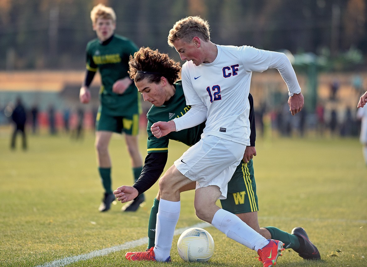 Whitefish's Austin Gunset works to keep the ball away from Wildcat Andrew Miner during the State A Championship against Columbia Falls on Saturday in Whitefish. (Whitney England/Whitefish Pilot)