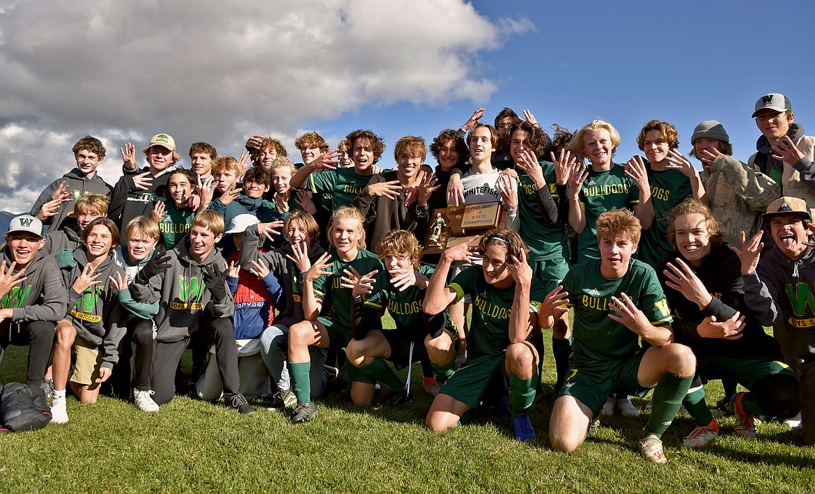 The Whitefish Bulldog boys soccer team celebrates winning its fourth-straight State A Championship on Saturday in Whitefish. (Whitney England/Whitefish Pilot)