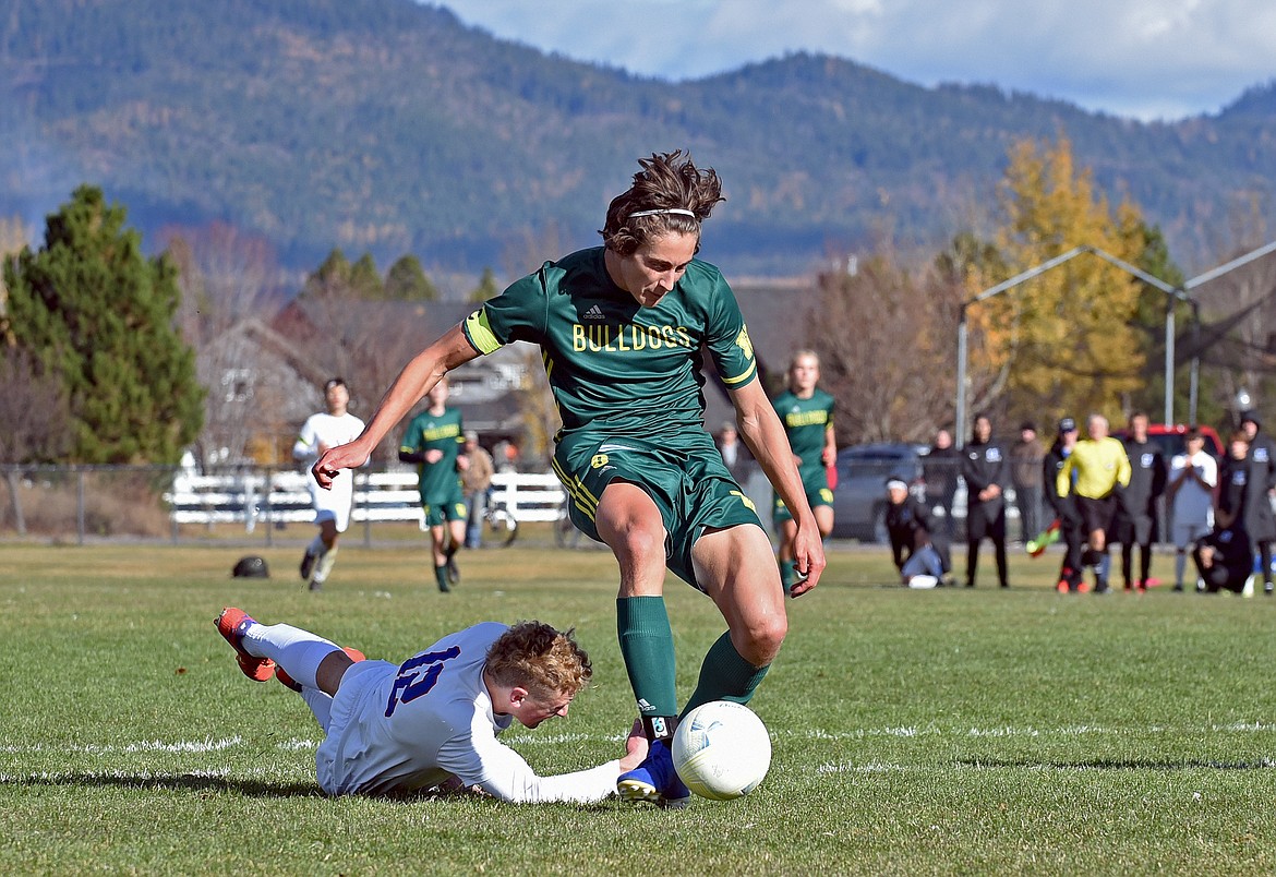 Bulldog senior Gabe Menicke scores the game-winning goal in the State A Soccer Championship against Columbia Falls on Saturday in Whitefish. (Whitney England/Whitefish Pilot)