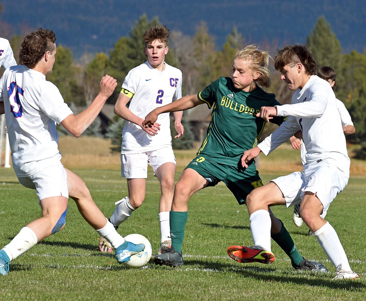 Whitefish senior Chase Sabin takes on three Wildcat defenders during the  State A Championship against Columbia Falls on Saturday in Whitefish. (Whitney England/Whitefish Pilot)