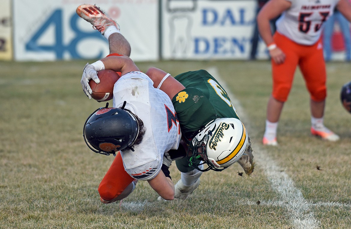 Whitefish's Ty Schwaiger takes down Frenchtown running back Garrett Schmill in the backfield during a playoff game against the Broncs on Saturday in Whitefish. (Whitney England/Whitefish Pilot)