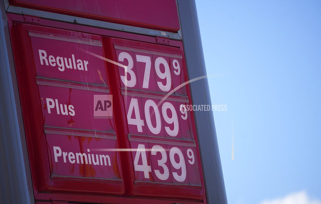 In this Oct. 24 2021, file photo, gas pump prices are posted on a sign at a Conoco station in southeast Denver. Americans’ opinions on the U.S. economy have soured noticeably in the past month, a new poll finds, as the cost of goods is rising nationwide, particularly gas prices. (AP Photo/David Zalubowski, File)