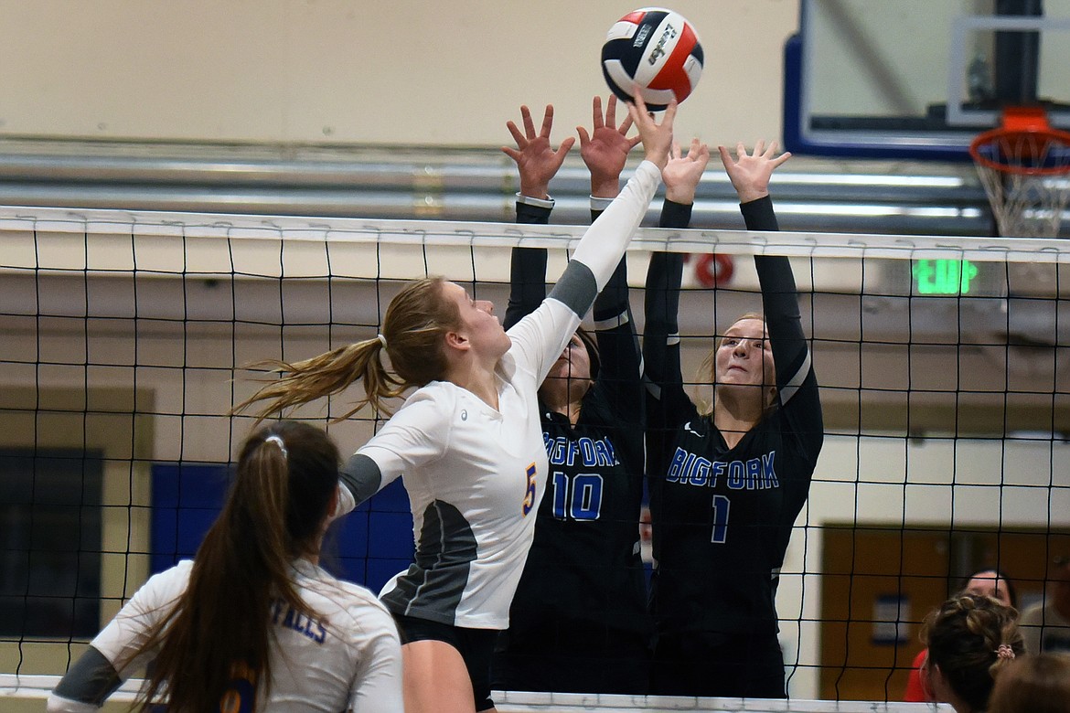 Natalie Roberts (5) of Thompson Falls tips the ball past Bigfork defenders Arianna Saari (10) and Inga Turner (1) during action at the 7B District Volleyball Tournament in St. Ignatius Saturday.