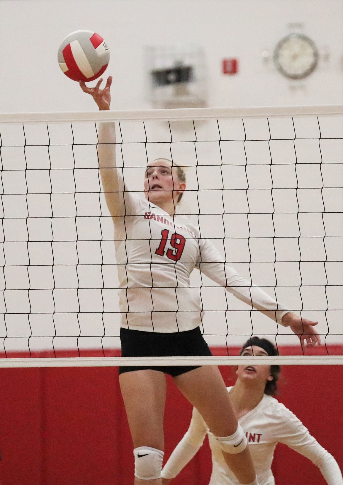 Senior Tori Pelkey tips the ball over the net during a match against Timberlake on Aug. 31 at Les Rogers Court. Pelkey was named to the all-league volleyball team.