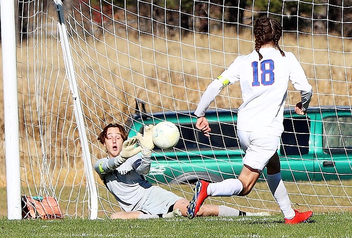 Whitefish keeper Will Peppmeier makes a PK save at the end of the game to secure the 3-2 win over Columbia Falls in the Class A boys soccer title game on Saturday. (Greg Nelson photo)