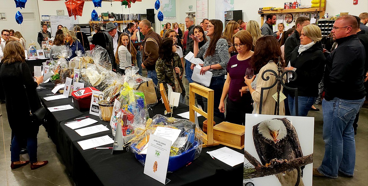 Guests browse some of the auction offerings at Give Hunger the Bird in 2018.