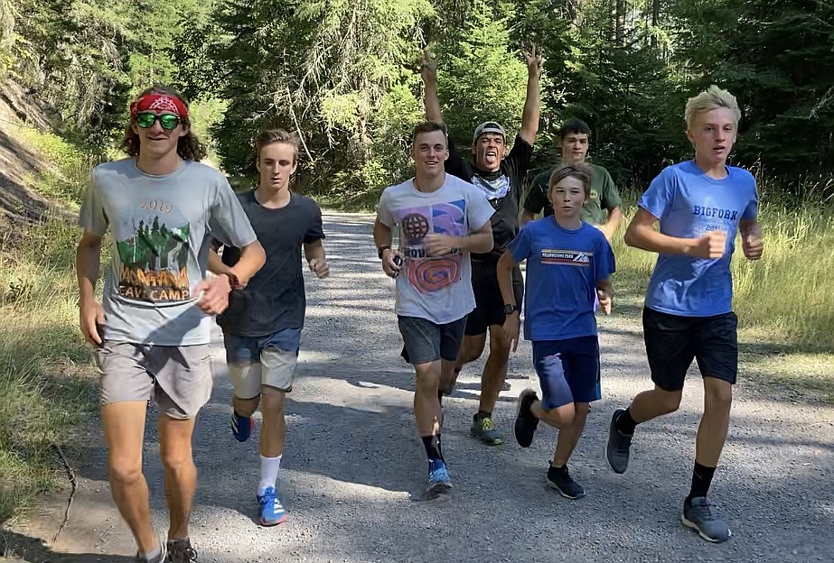 The Vikings cross country team of Elliot Sanford, North Nollan, Ryder Nollan, Colten Wroble, Colton Ballard, Elijah Albert and Jack Jensen take to the streets around Bigfork for some of their hundreds of miles of practice before winning a state title this season. (photo provided)