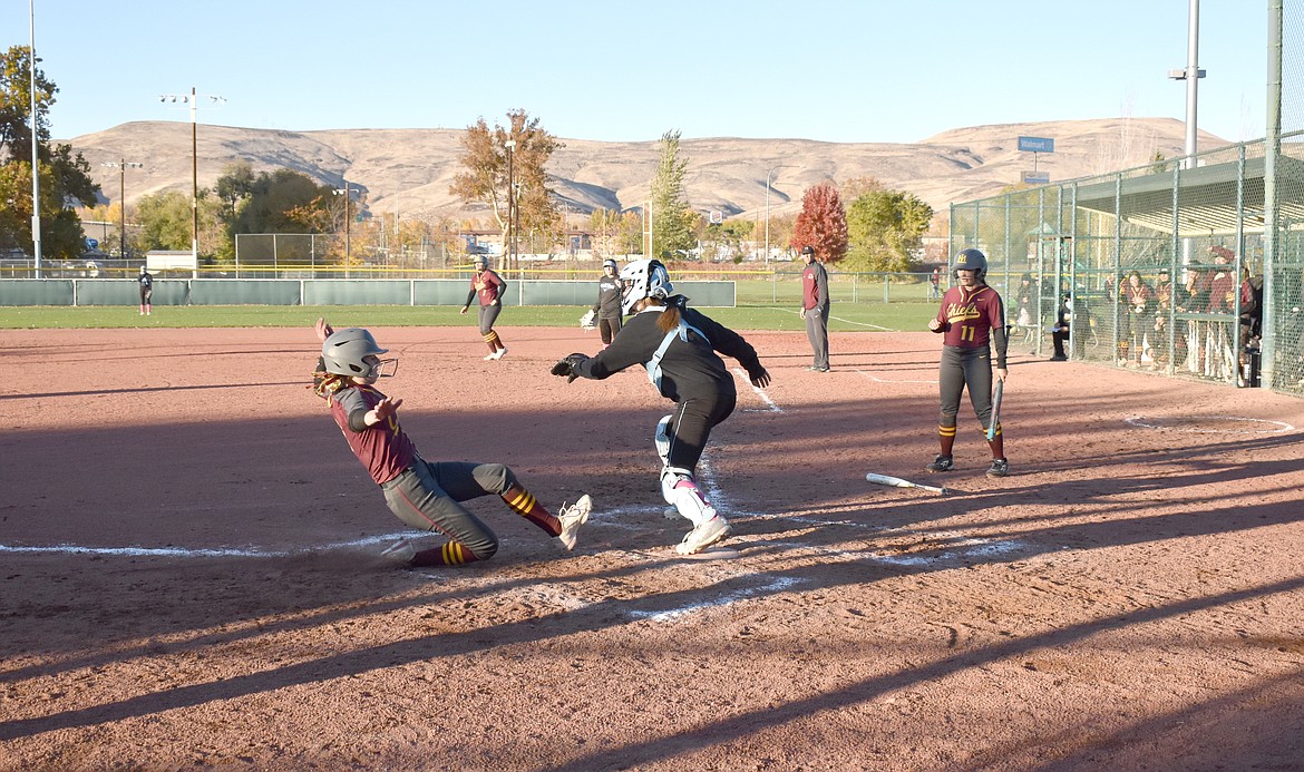 A Lady Chief slides into home plate during the game against Central Valley on Friday. Moses Lake lost the game, 7-24.