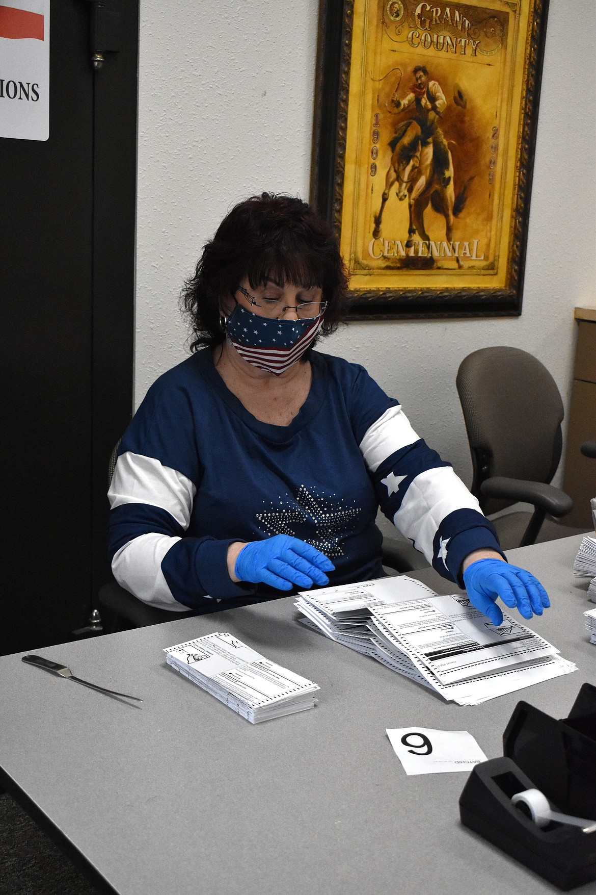 Dedra Osborn, certified elections administrator, unfolds ballots after they have been removed from their envelopes during the counting process at the Grant County Elections Office on Tuesday.