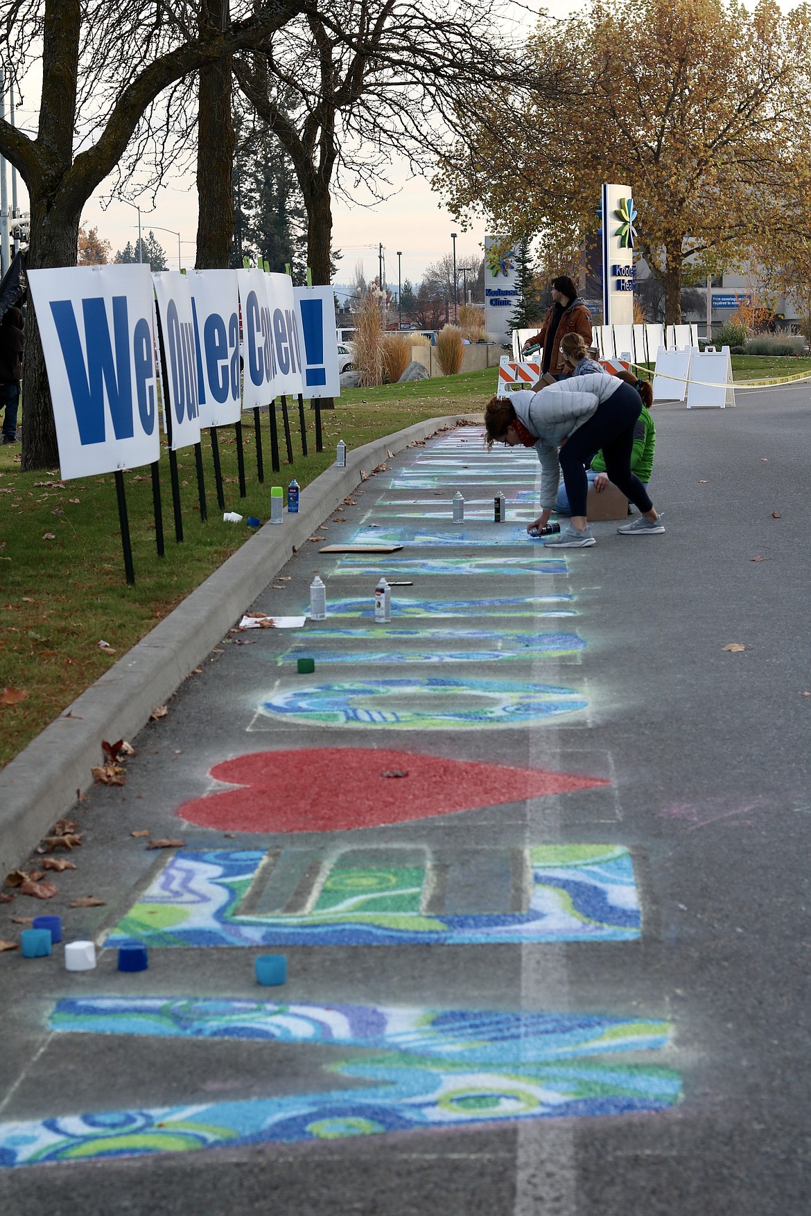 North Idaho College student artists have been spending the week spray painting a design created by 19-year-old student government President Annie Vladovska on the pavement on Kootenai Health Way on the east side of the hospital adjacent to U.S. 95 as a thank you message to health care workers. HANNAH NEFF/Press