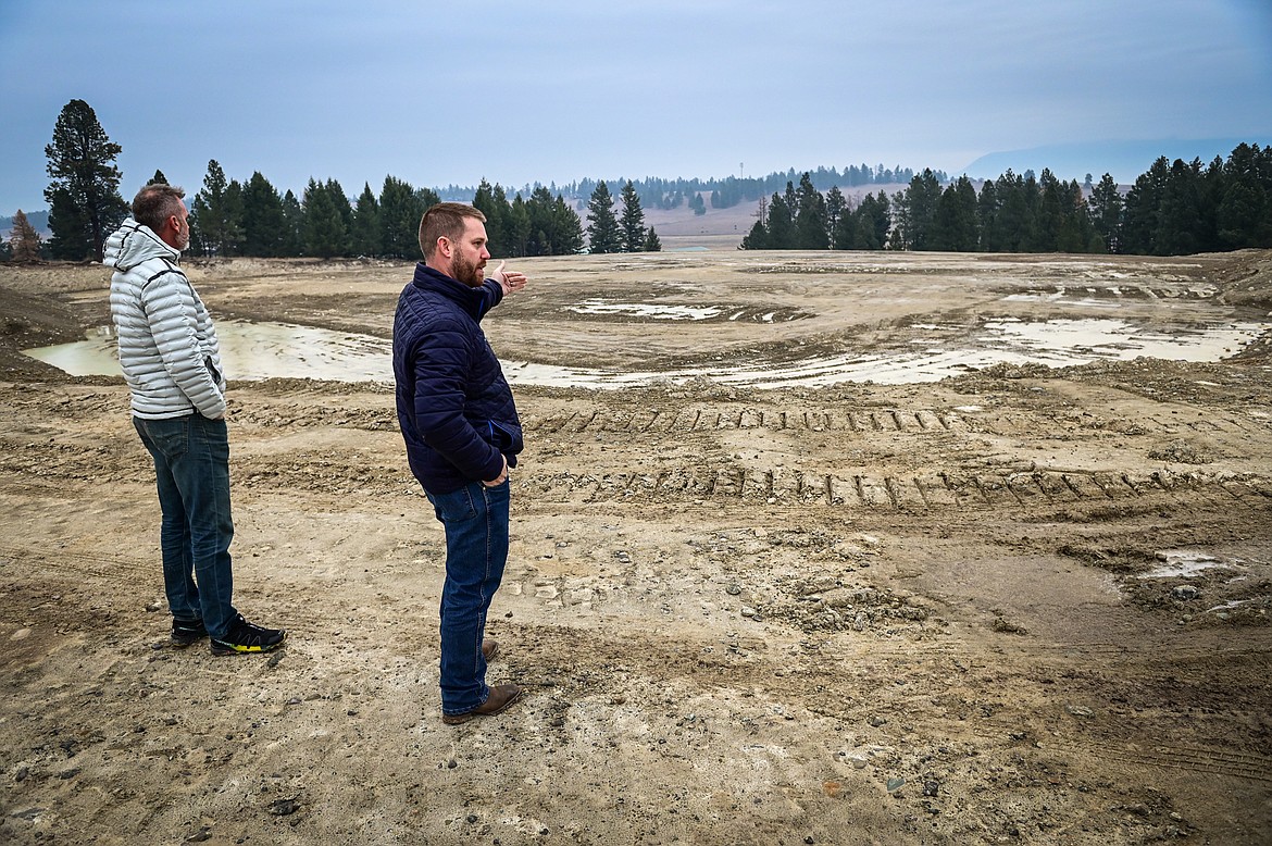 Erik Moore and Chris Kelly, with Ridge Run Baseball, stand atop a berm overlooking the development of a baseball stadium for a new Pioneer League team along U.S. 93 between Kalispell and Whitefish on Wednesday, Nov. 3. (Casey Kreider/Daily Inter Lake)