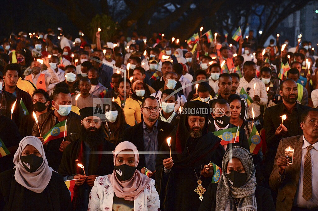 Members of the public join current and former Ethiopian military personnel to commemorate federal soldiers killed by forces loyal to the Tigray People's Liberation Front (TPLF) at the start of the conflict one year ago, at a candlelit event outside the city administration in Addis Ababa, Ethiopia Wednesday, Nov. 3, 2021. All sides in Ethiopia's yearlong war in the Tigray region have committed abuses marked by "extreme brutality" that could amount to war crimes and crimes against humanity, the U.N. human rights chief said Wednesday. (AP Photo)