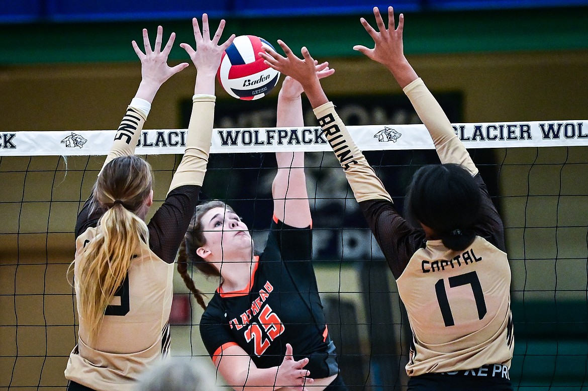 Flathead's Alliyah Stevens (25) goes up for a kill againt Helena Capital's Kaitlyn Haller (19) and Tey'ana Lintner (17) during Round 1 of the Western AA Volleyball Tournament at Glacier High School on Thursday, Nov. 4. (Casey Kreider/Daily Inter Lake)