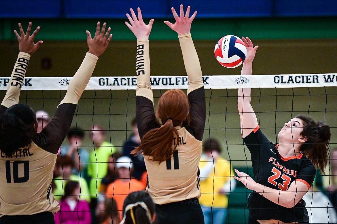 Flathead's Savanna Sterck (23) goes up for a kill against Helena Capital's Nyeala Herndon (10) and Parklyn Heller (11)  during Round 1 of the Western AA Volleyball Tournament at Glacier High School on Thursday, Nov. 4. (Casey Kreider/Daily Inter Lake)