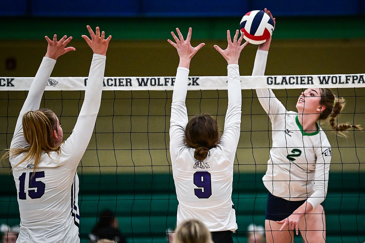 Glacier's Sidney Gulick (2) goes up for a kill against Butte's Ashley Olson (15) and Kennadie McMahon (9) during Round 1 of the Western AA Volleyball Tournament at Glacier High School on Thursday, Nov. 4. (Casey Kreider/Daily Inter Lake)