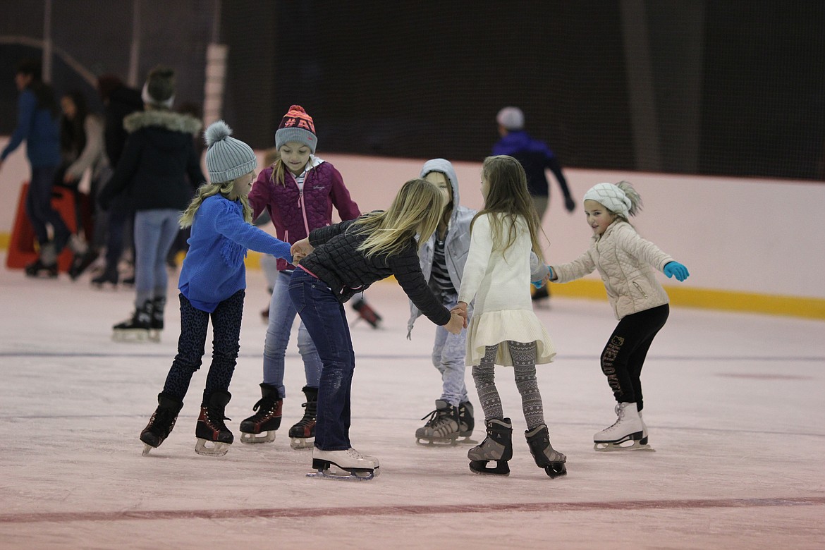 Children enjoy the Moses Lake ice rink in 2018. The rink was set to open Nov. 12, but will open a week later due to weather conditions.