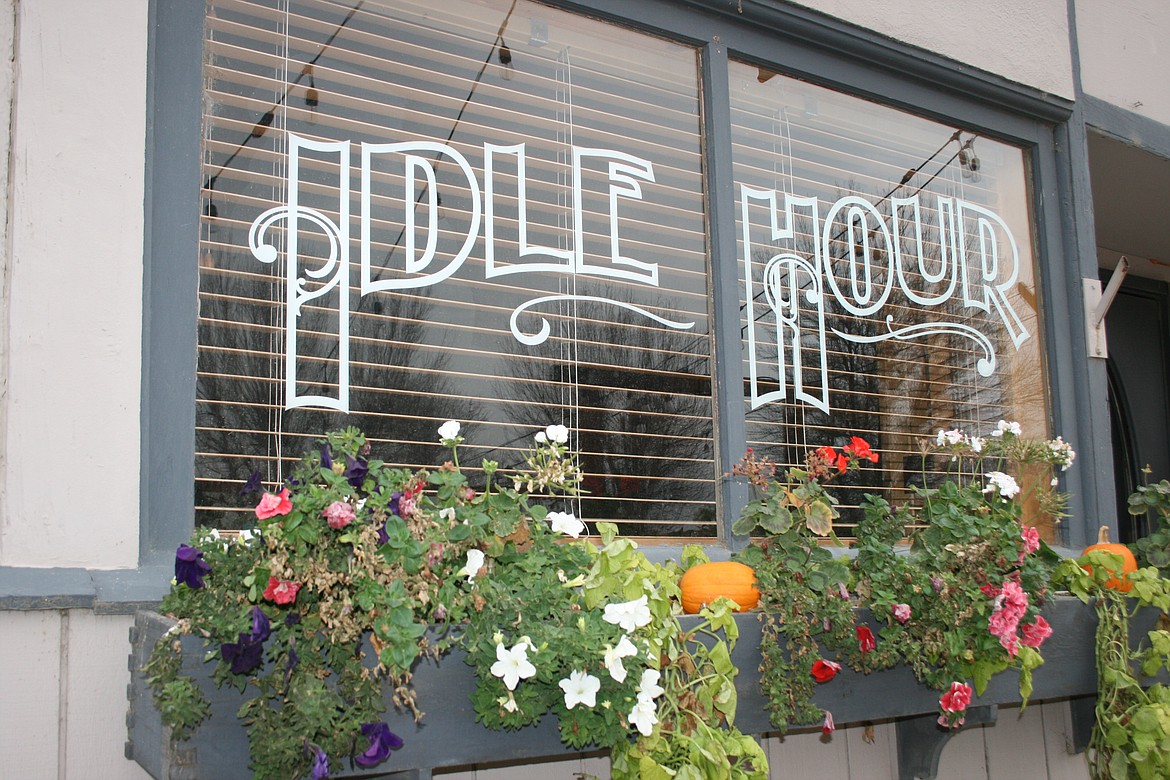 The windows at the Idle Hour Eatery & Spirits in Quincy reflect its heritage as the Idle Hour Saloon.