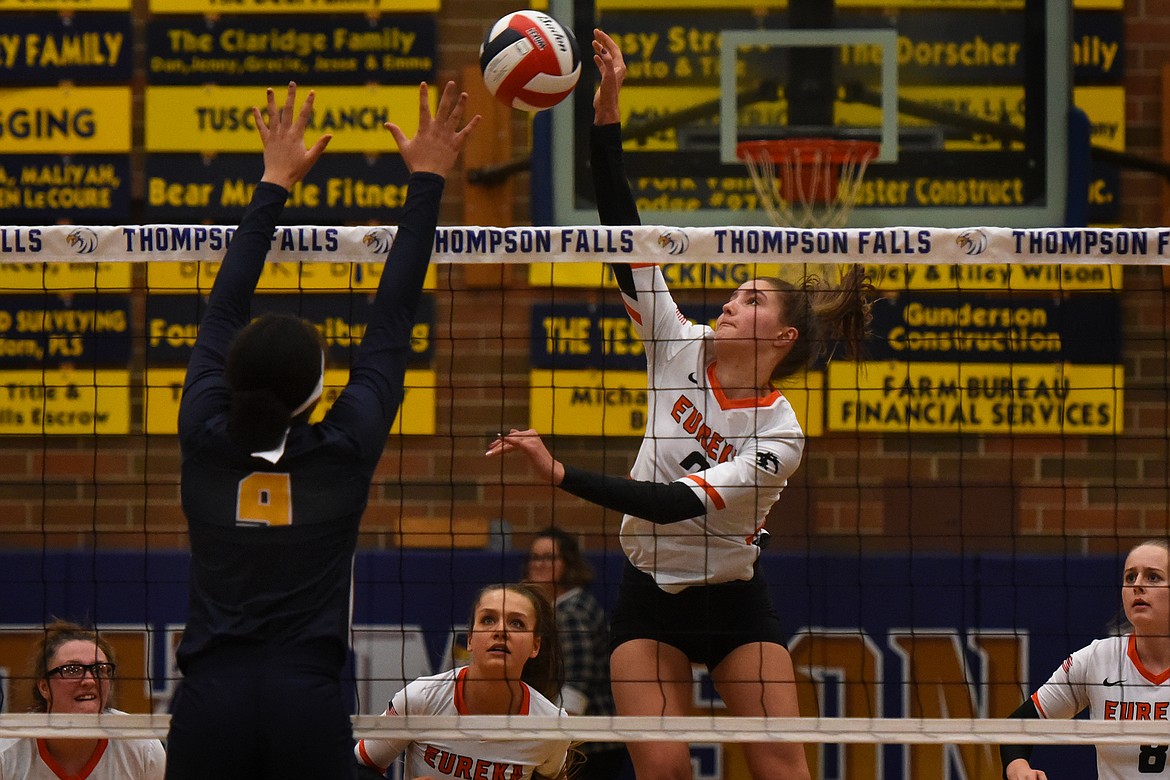 Eureka's Remmi Stanger spikes the ball past Deer Lodge's Nia McClanahan during opening-round action at the Western B Divisional Volleyball Tournament in Thompson Falls on Thursday, Nov. 4. (Jeremy Weber/Daily Inter Lake)