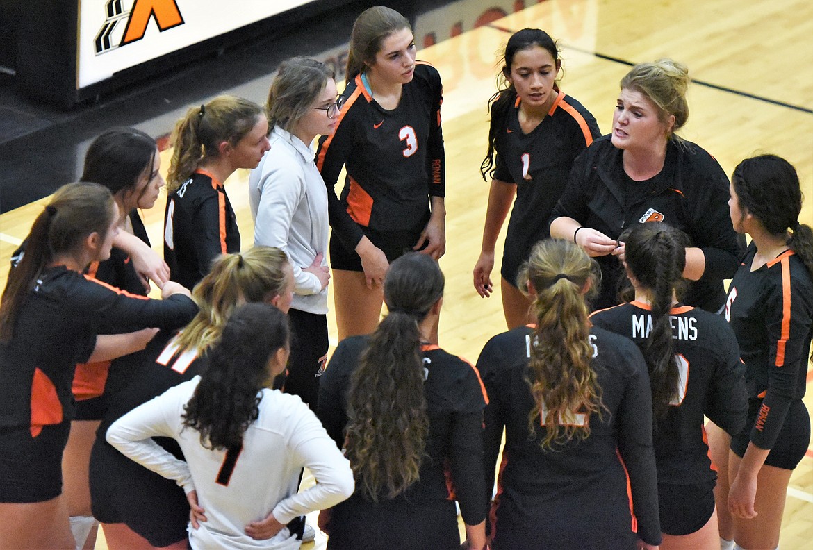 Maidens coach Lacey Phelan encourages her players before the fifth set against Corvallis on Thursday night. (Scot Heisel/Lake County Leader)
