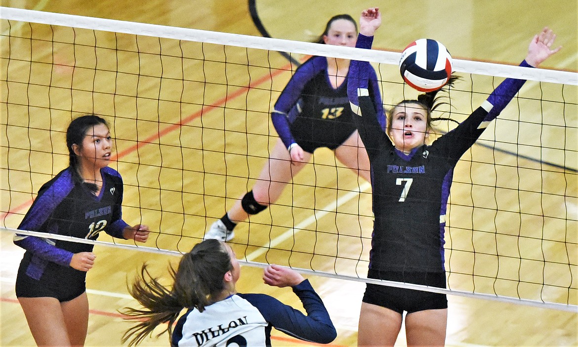 Polson senior Liz Tolley (7) gets the block for match point against Dillon as teammates Turquoise Pierre (12) and Grace Simonich watch. (Scot Heisel/Lake County Leader)
