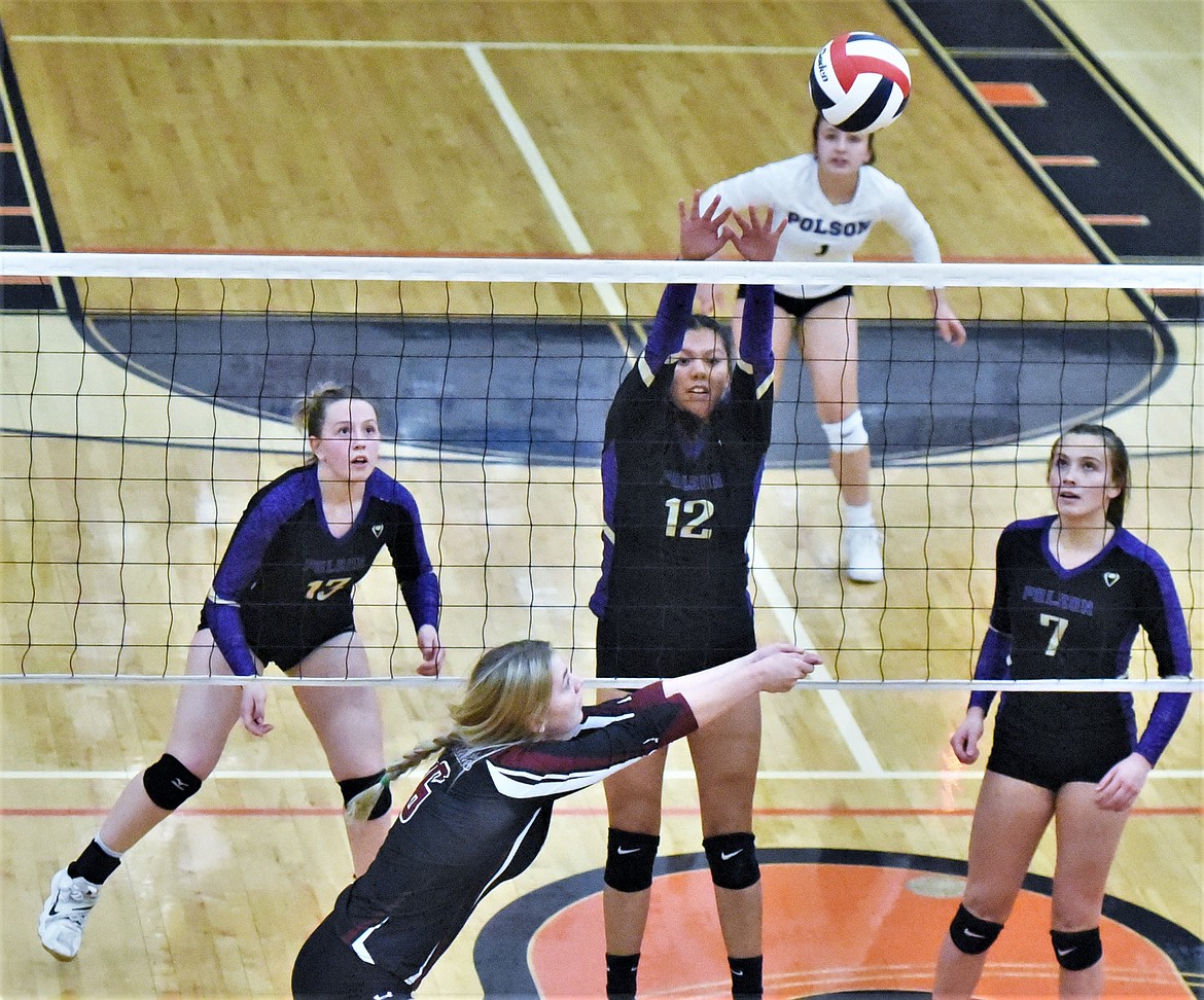 Polson senior Turquoise Pierre rises to defend a shot against Hamilton on Thursday while surrounded by teammates Grace Simonich (13), Julia Barnard (1) and Liz Tolley (7). (Scot Heisel/Lake County Leader)