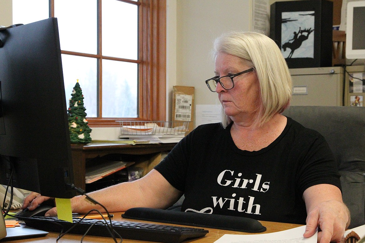 Kathy Ness, office administrator for Eureka Area Chamber of Commerce, at her desk Nov. 4. Ness has fielded many phone calls from Canadians wondering if the Chamber can help facilitate Covid-19 tests, but said that's beyond the scope of what the organization can do. (Will Langhorne/The Western News)