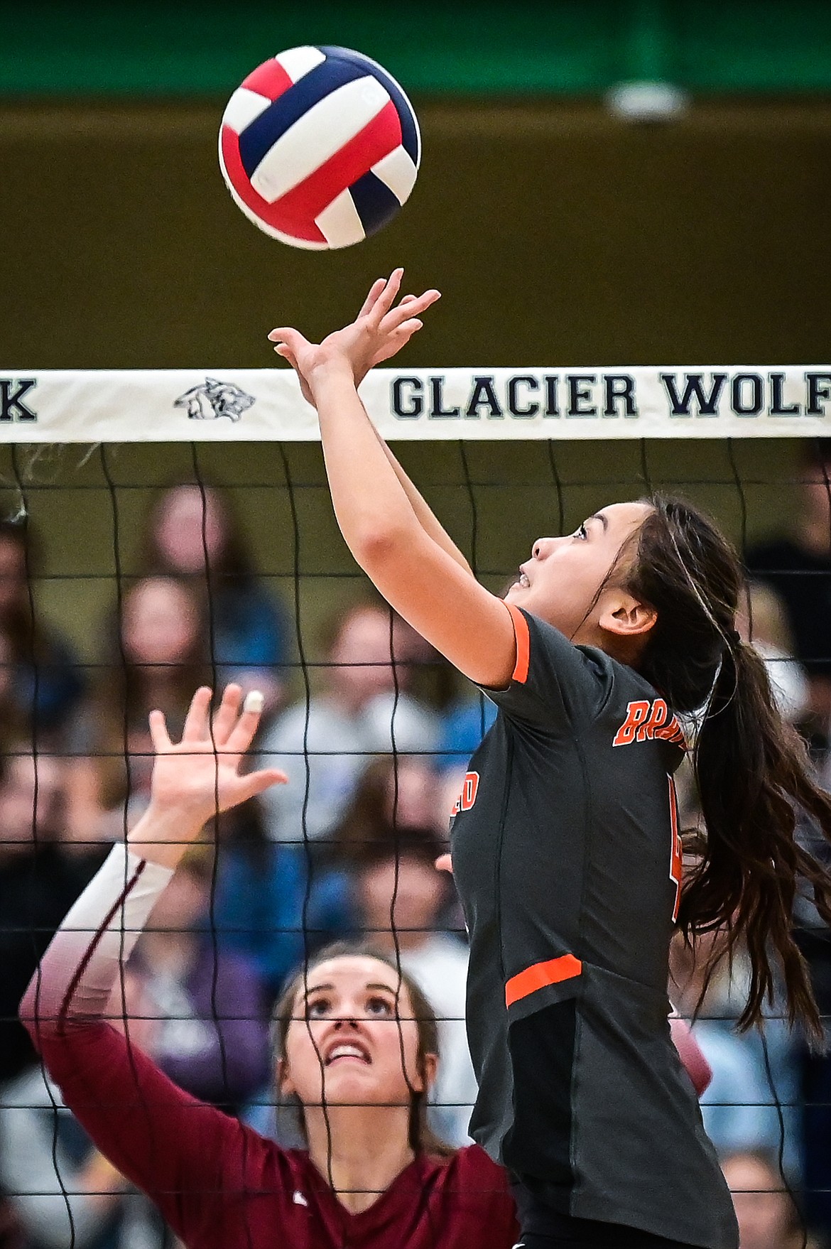 Flathead's Kylie Munsinger (4) sets for a teammate against Helena in Round 2 of the Western AA Volleyball Tournament at Glacier High School on Friday, Nov. 5. (Casey Kreider/Daily Inter Lake)