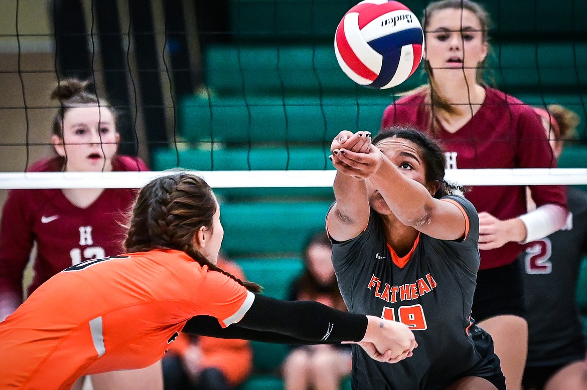 Flathead's Cyan Mooney (6) and Akilah Kubi (19) converge on a  ball against Helena in Round 2 of the Western AA Volleyball Tournament at Glacier High School on Friday, Nov. 5. (Casey Kreider/Daily Inter Lake)