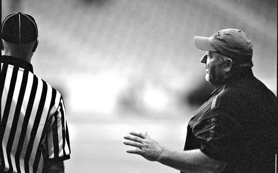 LESLIE MCPHAIL/Special to the Press
Wallace football coach Dave Rounds talks with an official during a game at the Kibbie Dome in Moscow. Rounds, 64, passed away suddenly on Oct. 29 while duck hunting.