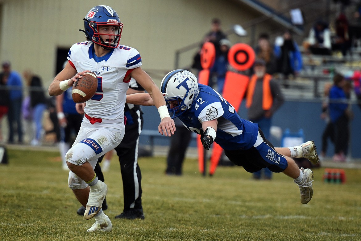 Bigfork quarterback Patrick Wallen avoids Townsend defensive back Dawson Sweat as he looks for a receiver in the third quarter of the Vikings 20-15 win at Townsend in the Class B state quarterfinals Saturday. (Jeremy Weber/Daily Inter Lake