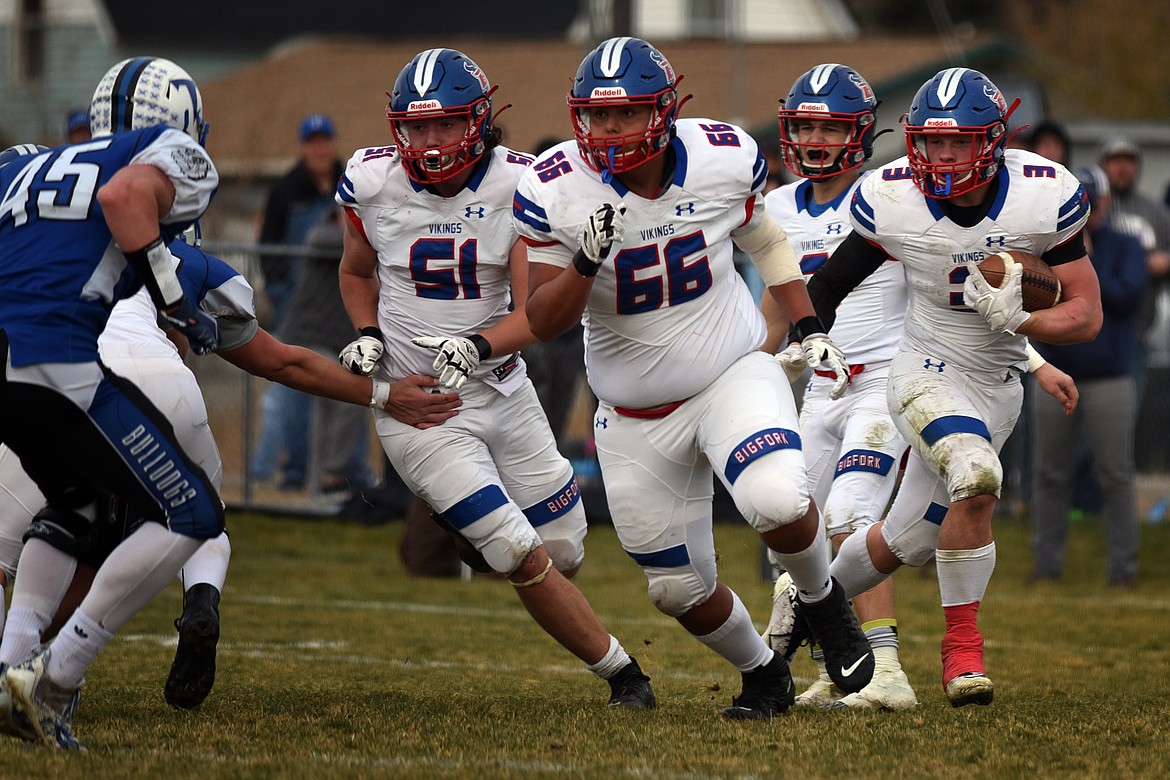 Vikings Ethan Rodriguez (66) and Jordan Betts (51) clear the way for runner Levi Taylor in the third quarter of Bigfork's 20-15 win at Townsend in the Class B state quarterfinals Saturday. (Jeremy Weber/Daily Inter Lake)