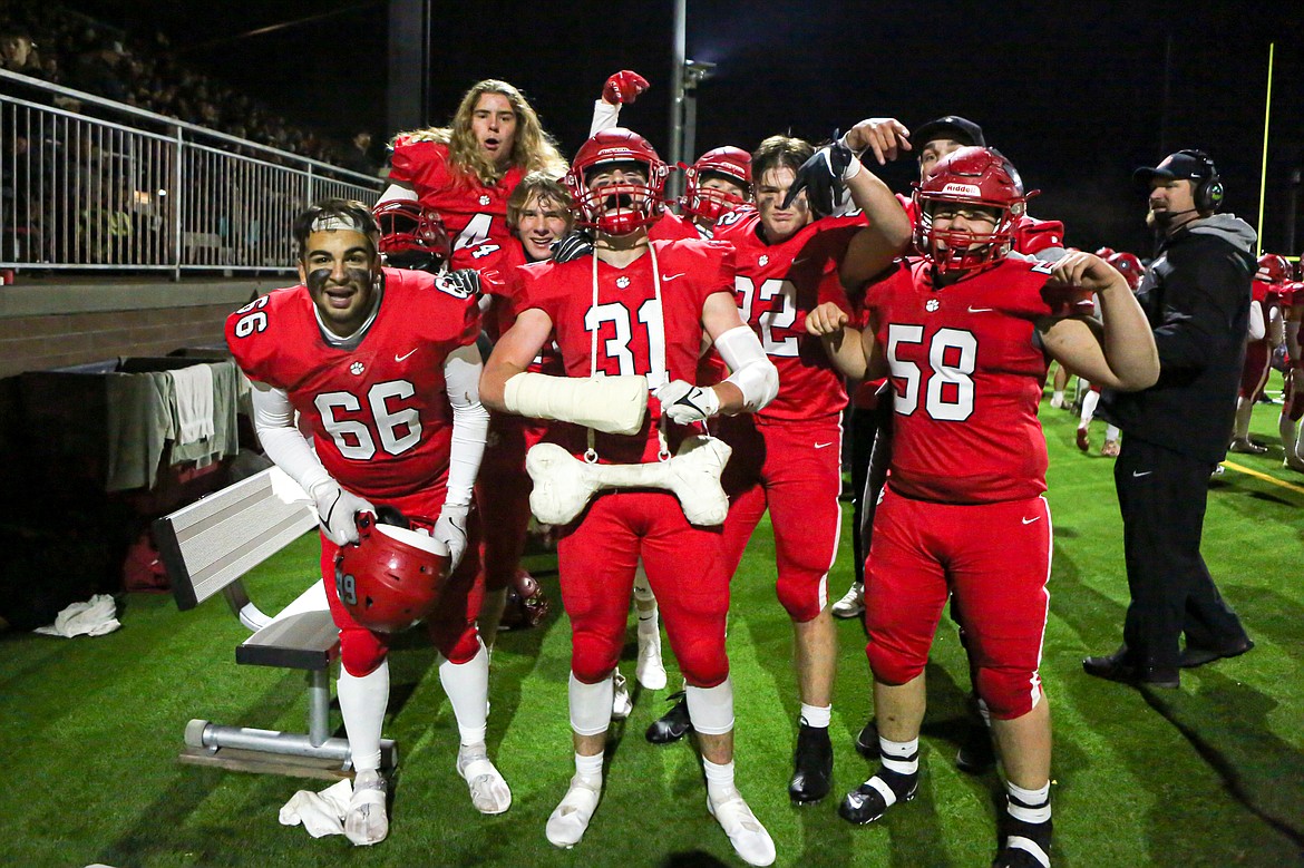 The Bulldogs celebrate with the turnover bone after forcing a fumble in the fourth quarter of Friday's game.