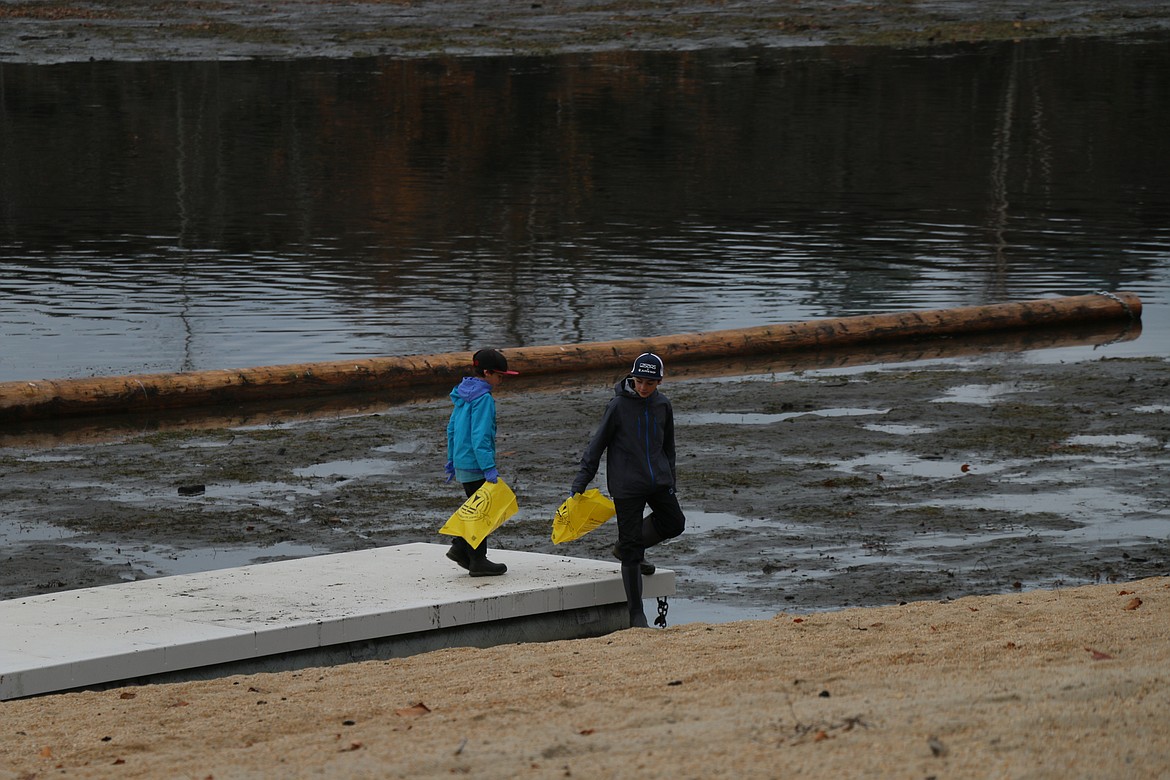 A young duo look for trash and litter at City Beach during Lake Pend Oreille Waterkeeper's annual cleanup on Saturday.